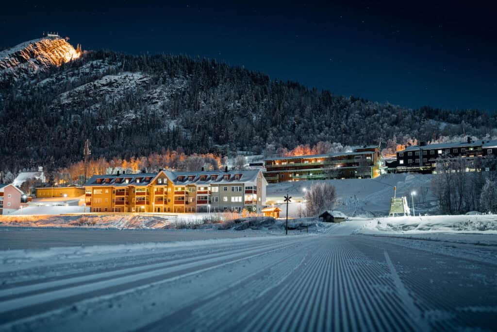 Snow-covered ski resort in Funäsdalen during winter with mountain views and chalets.